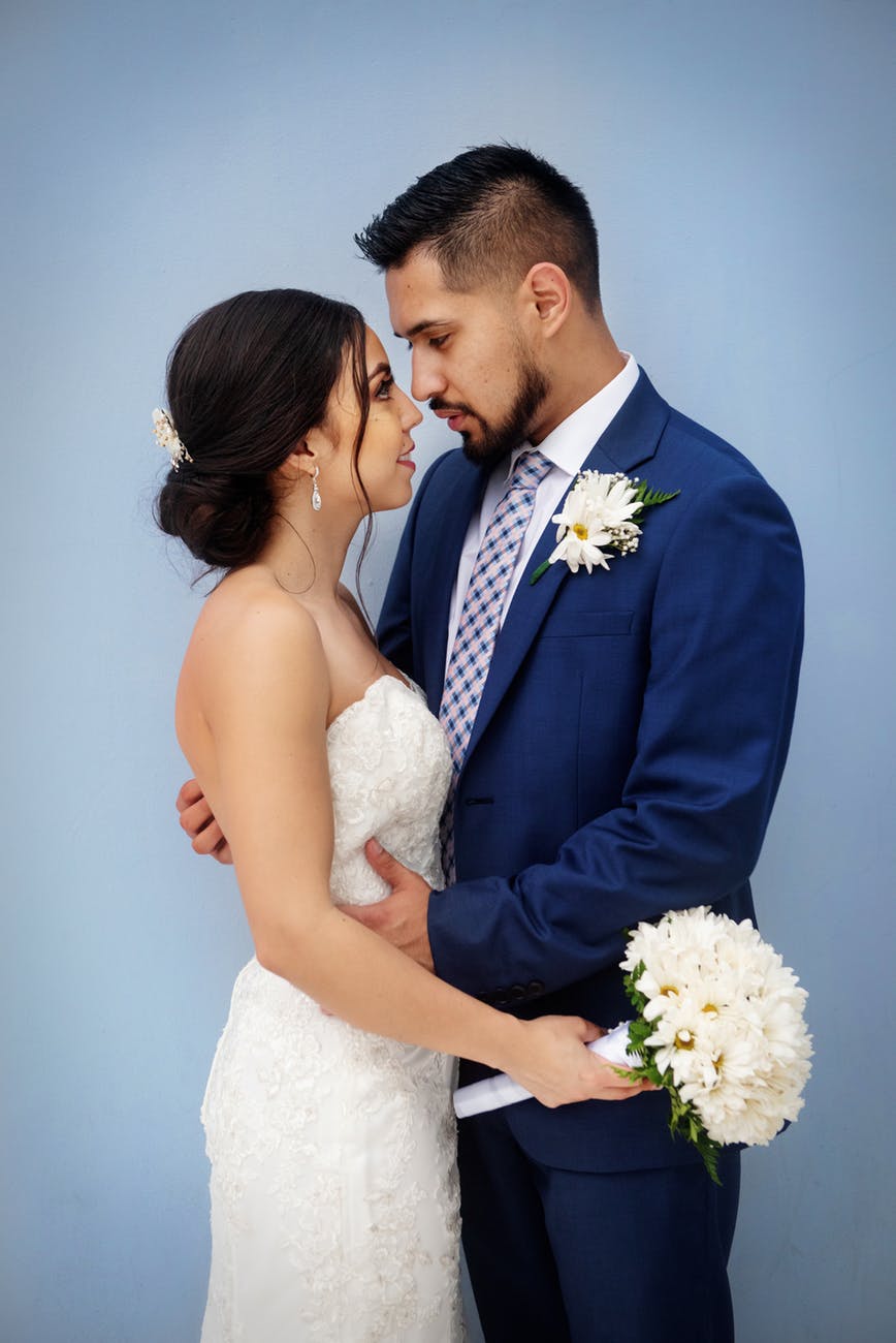 bride and groom standing next to each other